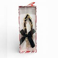 New Day brand Hello Lux Phone Wristlet featuring a gold-toned chain intertwined with black faux leather bows